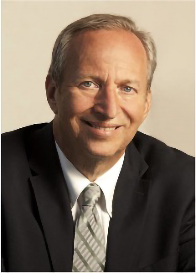 Lawrence A middle-aged man with short gray hair, wearing a black suit, white shirt, and striped tie, smiles at the camera against a plain light background, presenting the professional image of a 501(c)(3) organization’s executive.