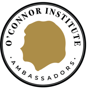 A round logo with a gold silhouette in the center, encircled by the words "O'Connor Institute Ambassadors" and "The Citizen" in black capital letters on a white background.