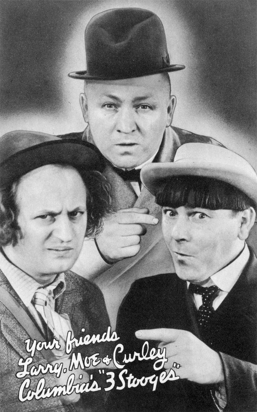 Black-and-white photo of the comedy trio The Three Stooges—Larry, Curly, and Moe—posing in suits and hats, with handwritten text: "Your friends Larry, Moe & Curley, Columbia's '3 Stooges.' Must Learn Civics.