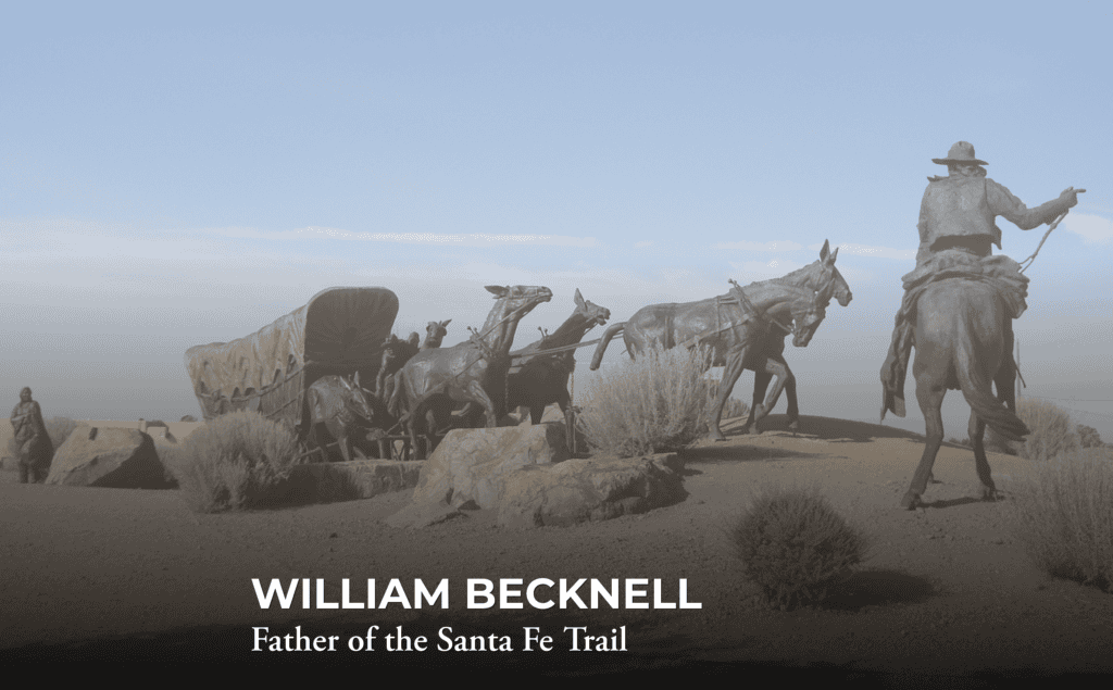 Bronze statues of a pioneer with a wagon and horses on a dirt path. Text reads: “WILLIAM BECKNELL Father of the Santa Fe Trail.” Bushes and a hazy blue sky are in the background.