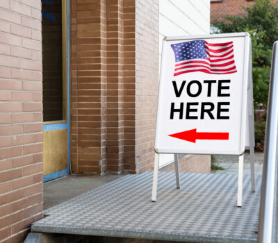 A sign with an American flag and the words 